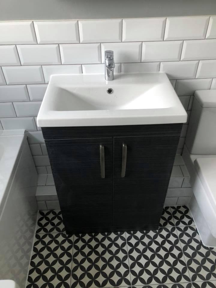 Professional plumber working on emergency repair